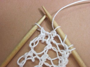 Yarn begins forward of needle