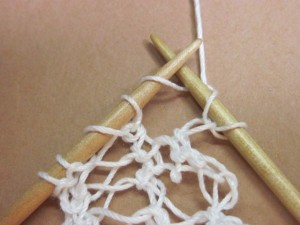 Complete that knit stitch as usual and drop the yarn over loop you had worked into off the left-hand needle