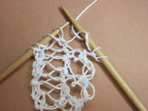 The purl stitch has been completed and the second yarn over loop dropped off the left-hand needle