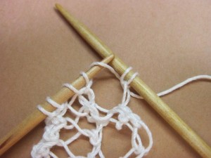 Knit into the yarn over of previous row, but don't remove the yarn over loop from left-hand needle yet