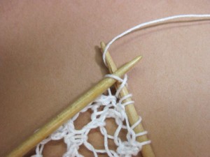 Wrap the yarn over the needle again to make the 2nd yarn over loop, then complete the knit stitch that follows 