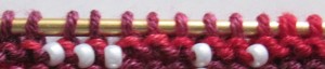 Beads are between stitches, rather than on the stitches themselves