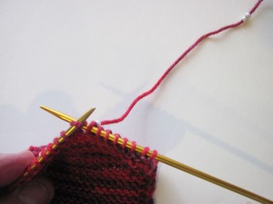 Slide a bead next to right-hand needle