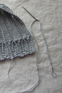 Doubled yarn tail threaded through tapestry needle