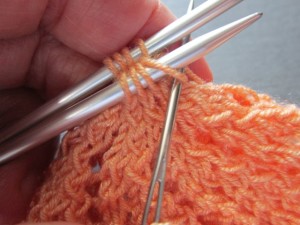 Insert tapestry needle knit-wise (i.e. left to right)