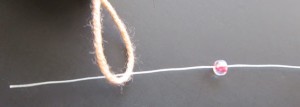 Put the stiff end through the yarn loop