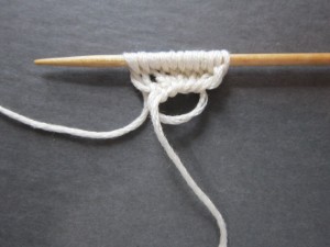 Pulling the yarn tail to close the loop