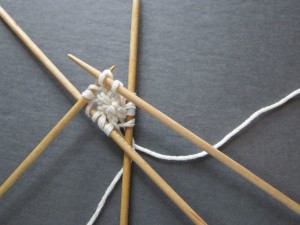 With 4th US 3 double point needle, knit a plain round