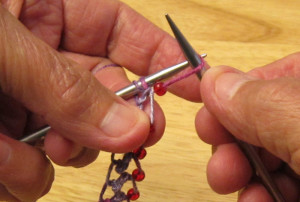 With yarn in front of right-hand needle 