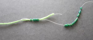 Push beads off the yarn onto the temporary thread