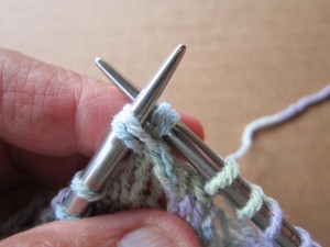 Cross right-hand needle behind left-hand needle